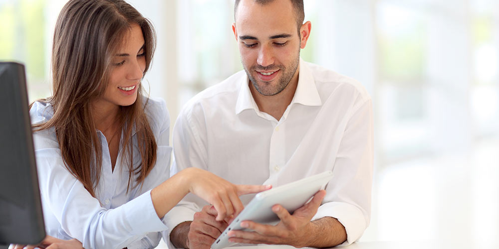 man and woman shopping from home on their computer