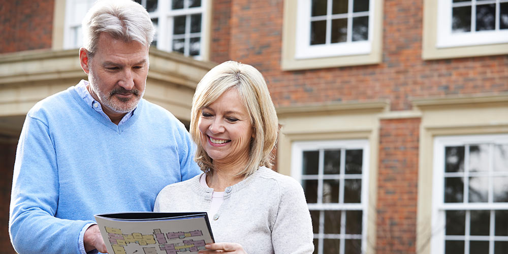 lady reading brochure with website url printed at bottom